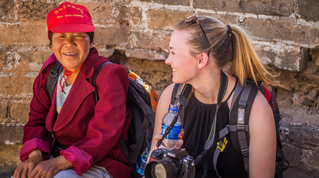 Olivia Healy Student Olivia Healy sitting with woman on a study abroad trip